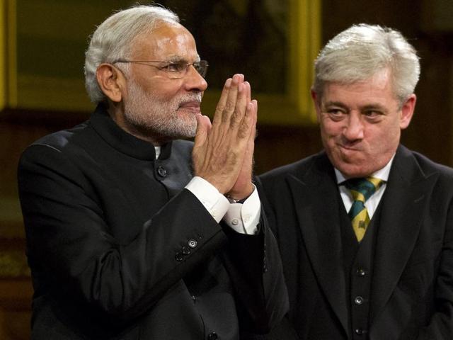 Indian Prime Minister Narendra Modi (L) acknowledges applause next to Speaker of the House of Commons John Bercow (R) after addressing members of parliament and invited guests in the Royal Gallery at the Houses of Parliament in central London on November 12, 2015. He will meet Queen Elizabeth II on Friday and address a huge rally at Wembley Stadium. (AFP)