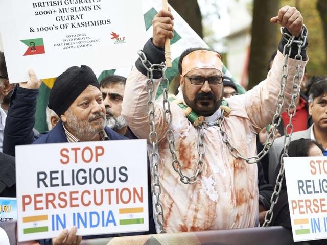 Protestors demonstrating against Indian Prime Minister Narendra Modi hold placards by Parliament square in central London on November 12, 2015. (AFP)