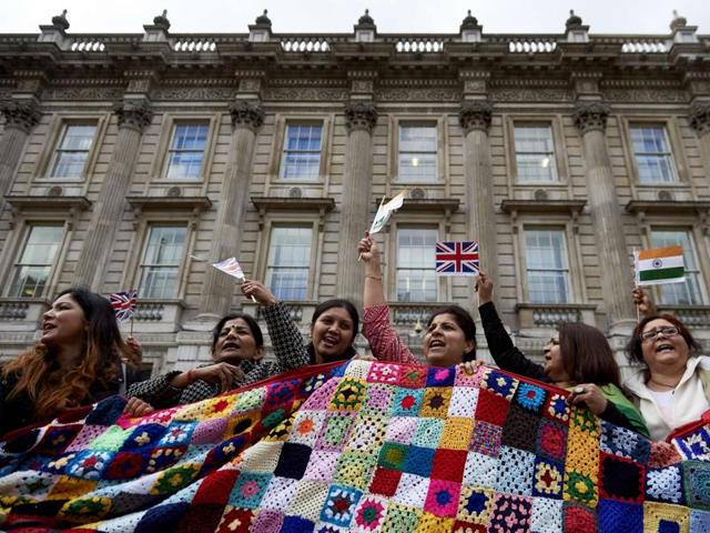 Supporters of Indian Prime Minister Narendra Modi wave flags and cheer as they attend a rally in Whitehall in central London on November 12, 2015. (AFP)