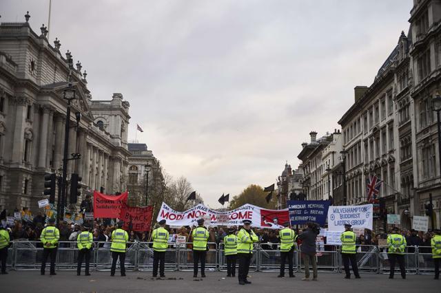 Protestors demonstrating against Prime Minister Narendra Modi hold placards by Parliament square in central London. (AFP) Protestors demonstrating against Prime Minister Narendra Modi hold placards by Parliament square in central London. (AFP)