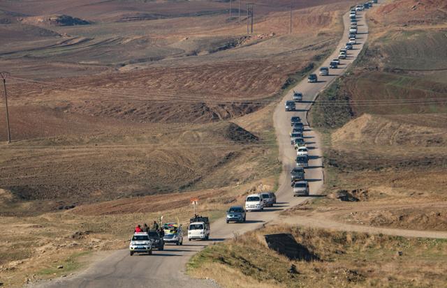 Kurdish People's Protection Units (YPG) fighters drive towards the Iraqi border with the coffin of fellow fighter John Robert Gallagher, a Canadian who died on November 4 in battle with Islamic State fighters, during his funeral in Hasaka, Syria. (REUTERS) Kurdish People's Protection Units (YPG) fighters drive towards the Iraqi border with the coffin of fellow fighter John Robert Gallagher, a Canadian who died on November 4 in battle with Islamic State fighters, during his funeral in Hasaka, Syria. (REUTERS)