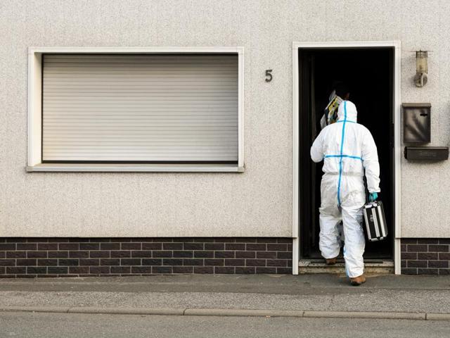 A police investigator in protective cloth enter a house in Wallenfels, southern Germany. (AP) A police investigator in protective cloth enter a house in Wallenfels, southern Germany. (AP)