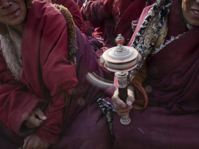 A Buddhist monk collects his belongings as vultures gather around a body of a deceased person during a sky burial near the Larung valley located some 3700 to 4000 metres above the sea level in Sertar county, Garze Tibetan Autonomous Prefecture, Sichuan province, China. (REUTERS) A Buddhist monk collects his belongings as vultures gather around a body of a deceased person during a sky burial near the Larung valley located some 3700 to 4000 metres above the sea level in Sertar county, Garze Tibetan Autonomous Prefecture, Sichuan province, China. (REUTERS)