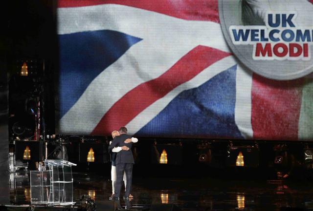 Prime Minister Narendra Modi embraces Britain's Prime Minister David Cameron on stage during an event at Wembley Stadium, in London. (REUTERS) Prime Minister Narendra Modi embraces Britain's Prime Minister David Cameron on stage during an event at Wembley Stadium, in London. (REUTERS)