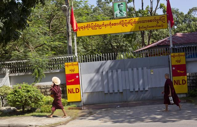 Buddhist monks walk past the entrance to Myanmar's opposition leader Aung San Suu Kyi's house in Yangon. Myanmar's president has promised a peaceful transfer of power to the victorious party of Suu Kyi in general elections, ensuring that the country's march toward greater democracy after decades of military rule will not be derailed. (AP Photo) Buddhist monks walk past the entrance to Myanmar's opposition leader Aung San Suu Kyi's house in Yangon. Myanmar's president has promised a peaceful transfer of power to the victorious party of Suu Kyi in general elections, ensuring that the country's march toward greater democracy after decades of military rule will not be derailed. (AP Photo)