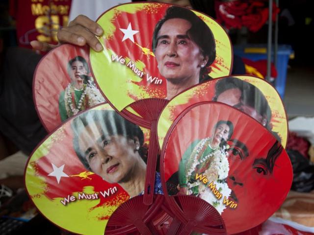 A member of the National League for Democracy arranges memorabilia of party leader Aung San Suu Kyi at the headquarters, in Yangon, Myanmar. Nobel laureate Aung San Suu Kyi's party on Friday secured a historic majority in Myanmar's Parliament, making it possible for them to form the southeast Asian country's first truly civilian government in more than half-a-century. (AP Photo) A member of the National League for Democracy arranges memorabilia of party leader Aung San Suu Kyi at the headquarters, in Yangon, Myanmar. Nobel laureate Aung San Suu Kyi's party on Friday secured a historic majority in Myanmar's Parliament, making it possible for them to form the southeast Asian country's first truly civilian government in more than half-a-century. (AP Photo)