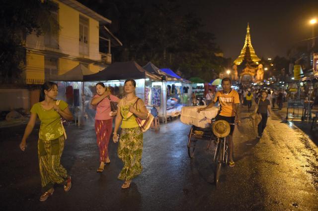 People walk in a streets of Yangon. Myanmar has been dominated by the military for half a century through direct junta rule and since 2011, by a quasi-civilian government run by its allies. (AFP Photo) People walk in a streets of Yangon. Myanmar has been dominated by the military for half a century through direct junta rule and since 2011, by a quasi-civilian government run by its allies. (AFP Photo)