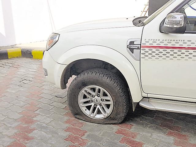 Bullets punctured tyres of the car in which the property dealer was travelling.(HT Photo) Bullets punctured tyres of the car in which the property dealer was travelling.(HT Photo)