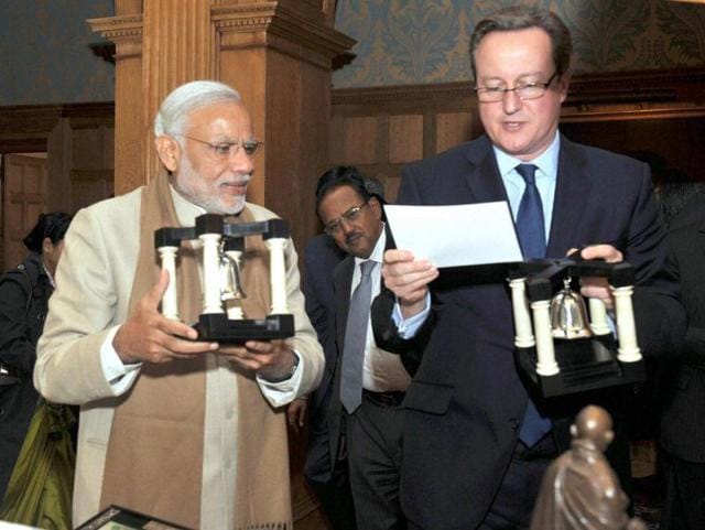 Prime Minister Narendra Modi presenting a gift to the Prime Minister of United Kingdom (UK), David Cameron in London on Friday. (PTI Photo) Prime Minister Narendra Modi presenting a gift to the Prime Minister of United Kingdom (UK), David Cameron in London on Friday. (PTI Photo)