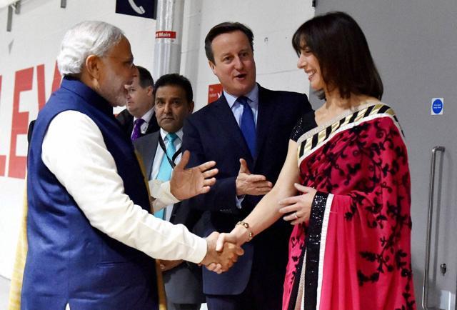Prime Minister Narendra Modi with his UK counterpart David Cameron arrives at Wembley Stadium for addresses Indian Community in London. (PTI) Prime Minister Narendra Modi with his UK counterpart David Cameron arrives at Wembley Stadium for addresses Indian Community in London. (PTI)