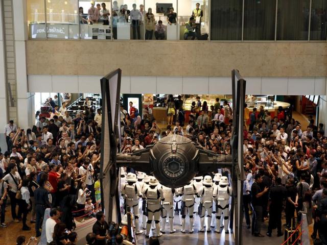 People take photos of Stormtroopers as they gather around a life-sized Star Wars TIE Fighter model on display at Singapore's Changi Airport. (REUTERS)