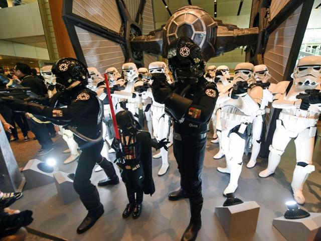 TIE pilots (front L and R) and Imperial Stormtroopers from the Star Wars film franchise are seen next to a life-sized model of a TIE Fighter (background) during a promotional event at the Changi International airport in Singapore. (AFP)