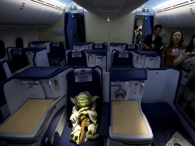 Visitors look at a Yoda plush toy sitting in the business class section during a tour of the Star Wars-themed All Nippon Airways ANA R2-D2 Boeing 787 Dreamliner aircraft in Singapore's Changi Airport. (REUTERS)