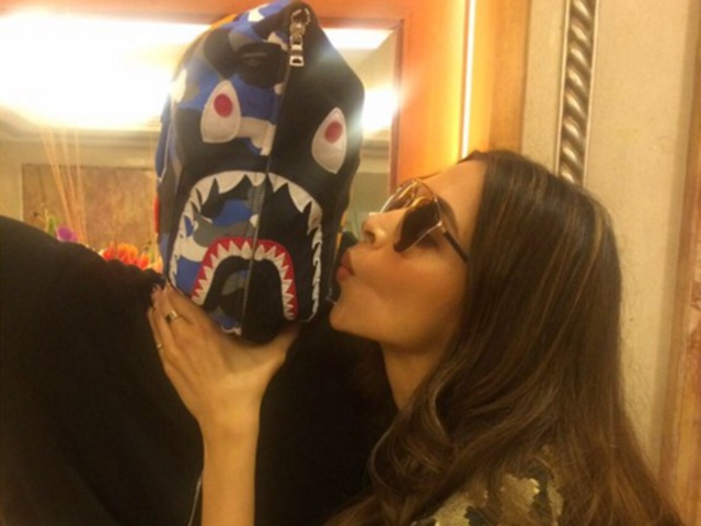 Gotta promote film, so what if it means kissing co-stars wearing masks? Deepika Padukone puts in another day at work. (Twitter)