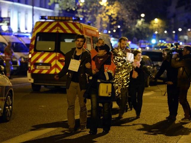People are evacuated on Boulevard des Filles du Calvaire near the Bataclan concert hall in central Paris. (AFP)