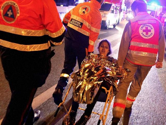 A person is being evacuated after the shooting outside Bataclan theatre in Paris. (AP) A person is being evacuated after the shooting outside Bataclan theatre in Paris. (AP)