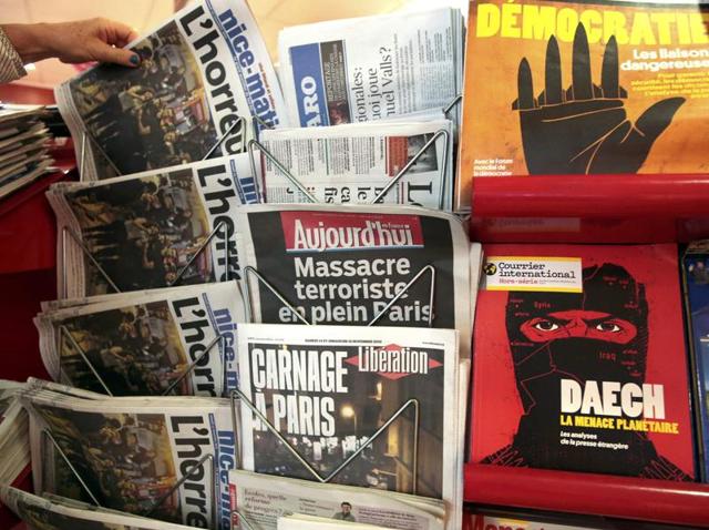 A woman takes the local newspaper at a news stand which displays a magazine (R bottom) which reads "Daech, the planetary threat" in Nice, France, November 14, 2015, the day after fatal shootings in the French capital. (REUTERS Photo) A woman takes the local newspaper at a news stand which displays a magazine (R bottom) which reads "Daech, the planetary threat" in Nice, France, November 14, 2015, the day after fatal shootings in the French capital. (REUTERS Photo)
