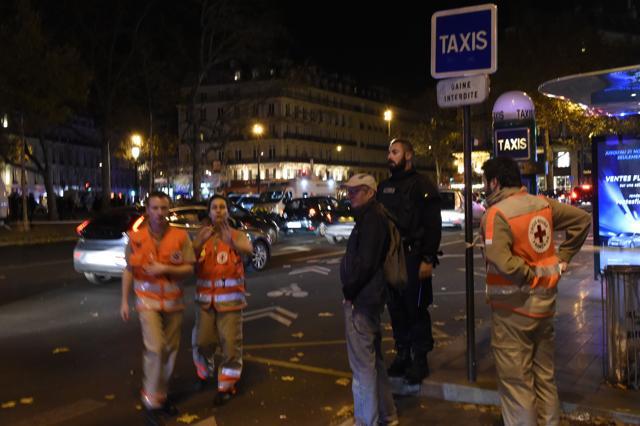 Rescue workers stand near Place de la Republique square in Paris on November 13. (AFP)