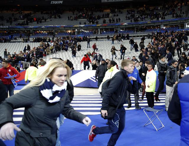 Spectators invade the pitch of the Stade de France stadium after the international friendly soccer match between France and Germany in Saint Denis, outside Paris, Friday, November 14, 2015. Hundreds of people spilled onto the field of the Stade de France stadium after explosions were heard nearby during a friendly match between the French and German national soccer teams. (AP) Spectators invade the pitch of the Stade de France stadium after the international friendly soccer match between France and Germany in Saint Denis, outside Paris, Friday, November 14, 2015. Hundreds of people spilled onto the field of the Stade de France stadium after explosions were heard nearby during a friendly match between the French and German national soccer teams. (AP)