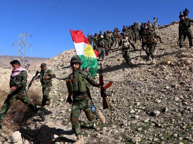 Iraqi autonomous Kurdish region's peshmerga forces and fighters from the Yazidi minority, a local Kurdish-speaking community which the Islamic State (IS) group had brutally targeted in the area, hold a Kurdish flag while entering the northern Iraqi town of Sinjar. Iraqi Kurdish leader Massud Barzani announced the "liberation" of Sinjar from the Islamic State group in an assault backed by US-led strikes. (AFP Photo) Iraqi autonomous Kurdish region's peshmerga forces and fighters from the Yazidi minority, a local Kurdish-speaking community which the Islamic State (IS) group had brutally targeted in the area, hold a Kurdish flag while entering the northern Iraqi town of Sinjar. Iraqi Kurdish leader Massud Barzani announced the "liberation" of Sinjar from the Islamic State group in an assault backed by US-led strikes. (AFP Photo)