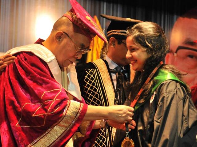 Tibetan spiritual leader the 14th Dalai Lama Tenzin Gyatso facilitates B Tech student Priyanka during the 5th convocation at Lovely Professional University near Jalandhar . (HT Photo ) Tibetan spiritual leader the 14th Dalai Lama Tenzin Gyatso facilitates B Tech student Priyanka during the 5th convocation at Lovely Professional University near Jalandhar . (HT Photo )
