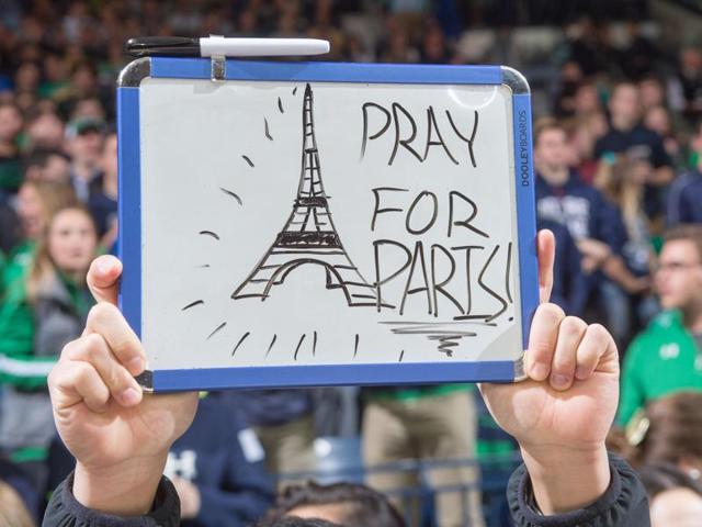A student holds a sign in recognition of the attacks in Paris before the game between the Notre Dame Fighting Irish and the St. Francis Red Flash at the Purcell Pavilion. (USA Today Sports)
