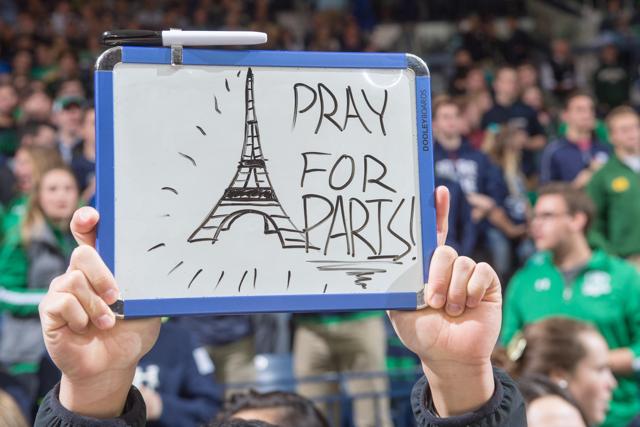 A student holds a sign in recognition of the attacks in Paris before the game between the Notre Dame Fighting Irish and the St. Francis Red Flash at the Purcell Pavilion. (USA Today Sports)