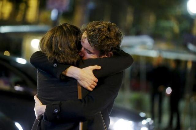 People hug on the street near the Bataclan concert hall, following fatal attacks in Paris, France. People hug on the street near the Bataclan concert hall, following fatal attacks in Paris, France.
