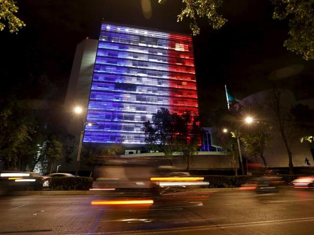 The Senate building is lit up in blue, white and red, the colors of the French flag, following the Paris terror attacks, in Mexico City (Reuters)