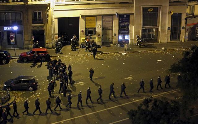 French police with protective shields walk in line near the Bataclan concert hall following fatal shootings in Paris. (Reuters)