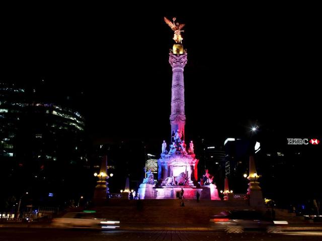 The Angel de la Independencia monument is lit up in blue, white and red, the colors of the French flag. (Reuters)