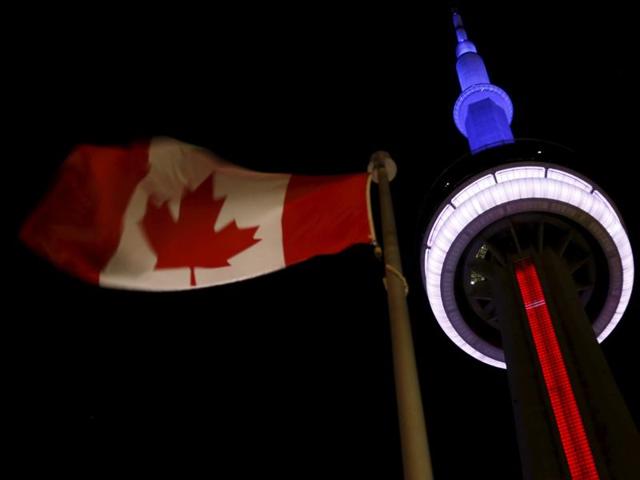 The landmark CN Tower is lit blue, white and red in the colors of the French flag following Paris attacks, in Toronto. (Reuters)
