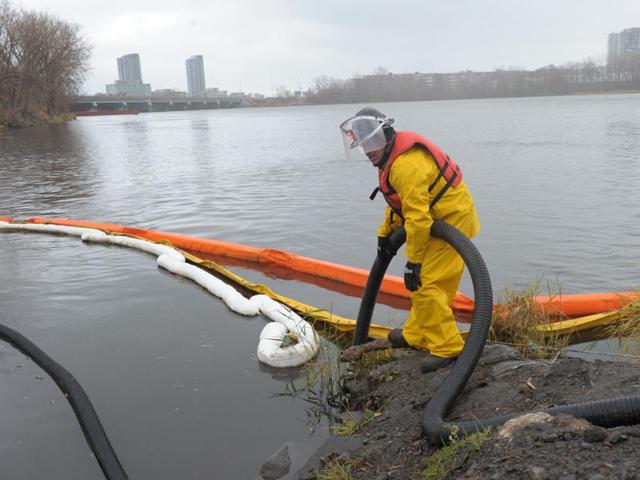 A water cleanup specialist is seen at a floating dam designed to filter trash in Montreal. (AFP) A water cleanup specialist is seen at a floating dam designed to filter trash in Montreal. (AFP)
