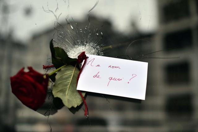 A rose with a sign reading 'In the name of what?' is pictured in a bullet hole in the window of a Japanese restaurant next to the cafe 'La Belle Equipe', Rue de Charonne, in Paris. (AFP) A rose with a sign reading 'In the name of what?' is pictured in a bullet hole in the window of a Japanese restaurant next to the cafe 'La Belle Equipe', Rue de Charonne, in Paris. (AFP)
