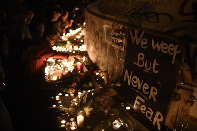 Candles have been lit at a pop-up memorial set near the cafe "Bonne biere", one of the site of the attacks in Paris on November 14. (AFP Photo) Candles have been lit at a pop-up memorial set near the cafe "Bonne biere", one of the site of the attacks in Paris on November 14. (AFP Photo)