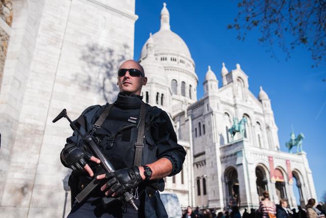 A French police officer patrols at the Sacre Coeur basilica in Paris on Sunday. (AP) A French police officer patrols at the Sacre Coeur basilica in Paris on Sunday. (AP)