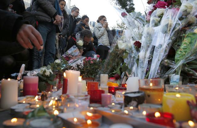 Mourners place flowers and light candles outside the Bataclan concert hall in Paris. (AP) Mourners place flowers and light candles outside the Bataclan concert hall in Paris. (AP)