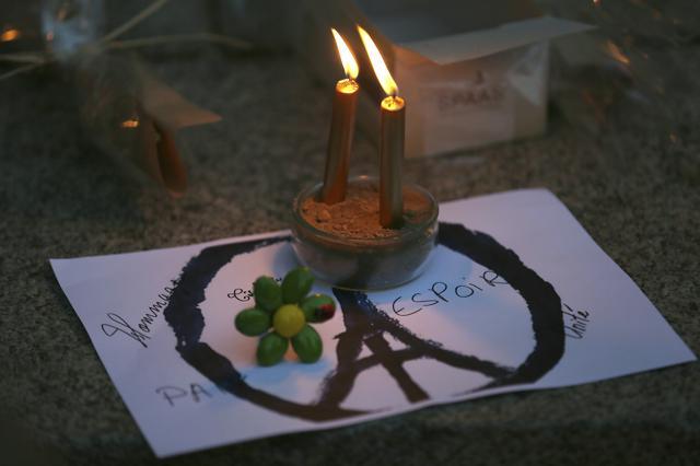 Candles are put on a peace sign combined with the Eiffel Tower at a temporary memorial for the victims of the Paris attacks in Rennes, western France (AP) Candles are put on a peace sign combined with the Eiffel Tower at a temporary memorial for the victims of the Paris attacks in Rennes, western France (AP)
