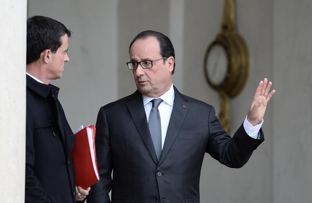 France's President Francois Hollande (R), accompanied by France's Prime minister Manuel Valls, gestures while leaving the Elysee Palace in Paris after a security meeting. (AFP) France's President Francois Hollande (R), accompanied by France's Prime minister Manuel Valls, gestures while leaving the Elysee Palace in Paris after a security meeting. (AFP)