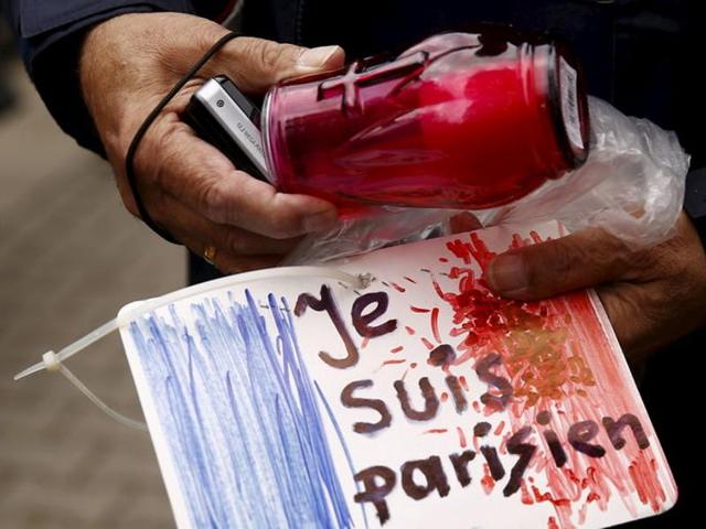 A man holds a candle and a drawing depicting the French flag and carrying the words "I am Parisian" in front of the French embassy after attacks in Paris on Friday, in Warsaw, Poland November 14, 2015. REUTERS/Kacper Pempel (REUTERS) A man holds a candle and a drawing depicting the French flag and carrying the words "I am Parisian" in front of the French embassy after attacks in Paris on Friday, in Warsaw, Poland November 14, 2015. REUTERS/Kacper Pempel (REUTERS)