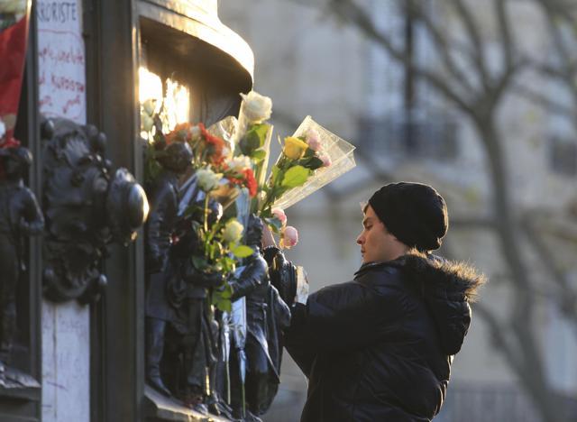 A man places flowers on a statue at Place de la Republique near sites of the deadly attacks in Paris. (Reuters) A man places flowers on a statue at Place de la Republique near sites of the deadly attacks in Paris. (Reuters)