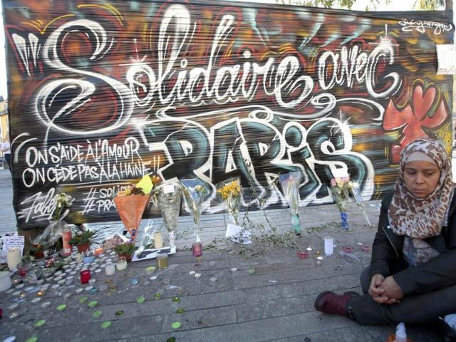 A woman sits by a poster which reads "Solidarity with Paris" in Nice, France. (REUTERS) A woman sits by a poster which reads "Solidarity with Paris" in Nice, France. (REUTERS)