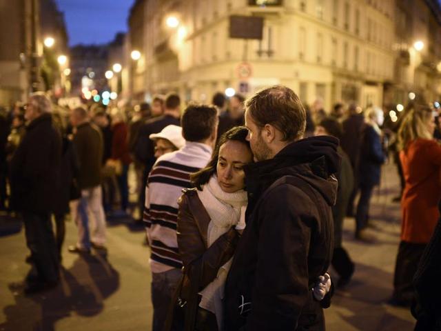 People take part in a gathering near Le Carillon restaurant, one of the site of the attacks in Paris. (AFP) People take part in a gathering near Le Carillon restaurant, one of the site of the attacks in Paris. (AFP)