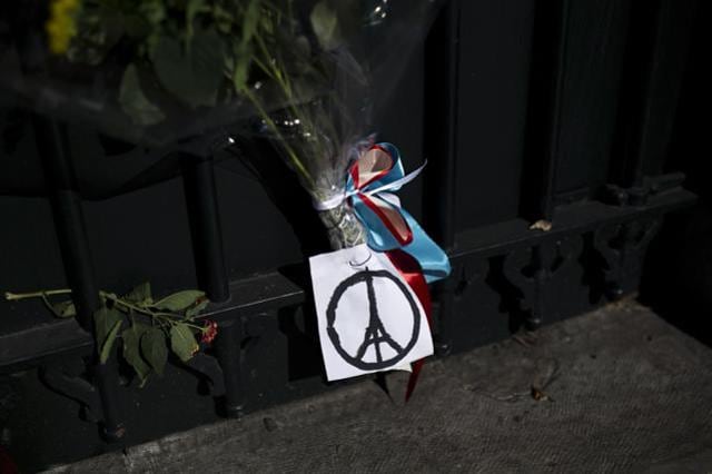 Flowers and a peace sign in the shape of the Parisian landmark the Eiffel Tower, are seem outside French Embassy in Greece. (AFP) Flowers and a peace sign in the shape of the Parisian landmark the Eiffel Tower, are seem outside French Embassy in Greece. (AFP)
