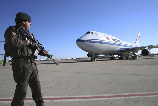 A Turkish police officer secures the area as the place carrying Chinese President Xi Jinping arrives in Antalya, Turkey on Saturday. (AP) A Turkish police officer secures the area as the place carrying Chinese President Xi Jinping arrives in Antalya, Turkey on Saturday. (AP)