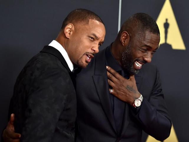 Will Smith and Idris Elba share a light moment at the Governors Awards red carpet in LA. (AP)