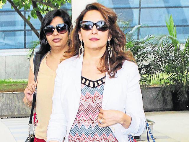 Actor Madhuri Dixit-Nene looks pretty as ever in a printed shirt paired with a white blazer and blue jeans. (Photo: Yogen Shah/HT)