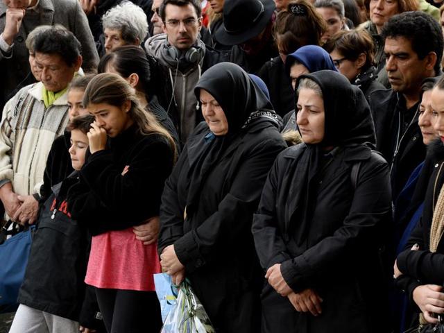 People observe a minute of silence on November 16, 2015 at the Bataclan concert hall in Paris. (AFP Photo) People observe a minute of silence on November 16, 2015 at the Bataclan concert hall in Paris. (AFP Photo)