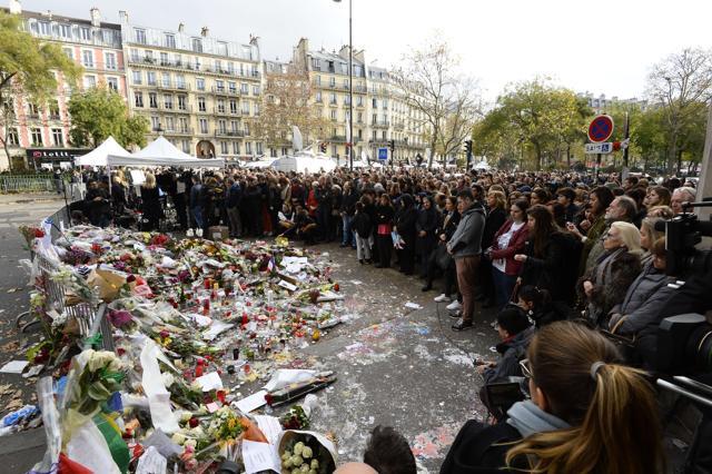 People observe a minute of silence at the Bataclan concert hall in Paris. (AFP) People observe a minute of silence at the Bataclan concert hall in Paris. (AFP)