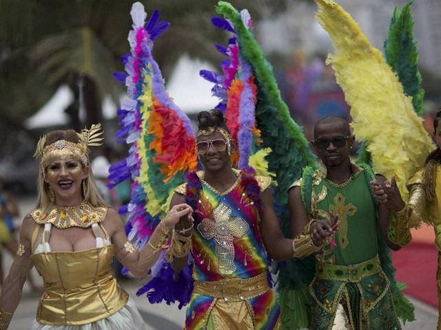 The Copacabana beach in Rio de Janeiro was packed to capacity on November 15 for the city’s 20th Gay Pride Parade. People pose for pictures as they wear feathered angel wings during the parade. (AP)